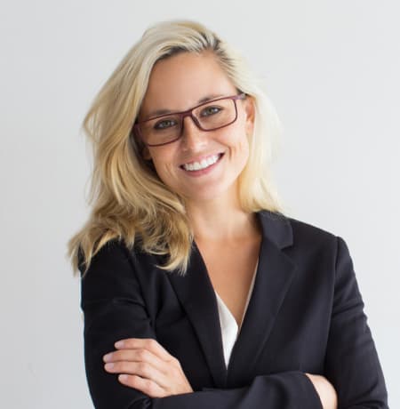 A woman in a business suit and glasses