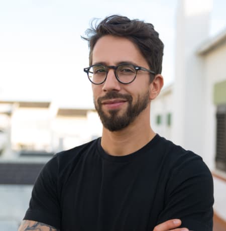 A man wearing glasses and a dark T-shirt